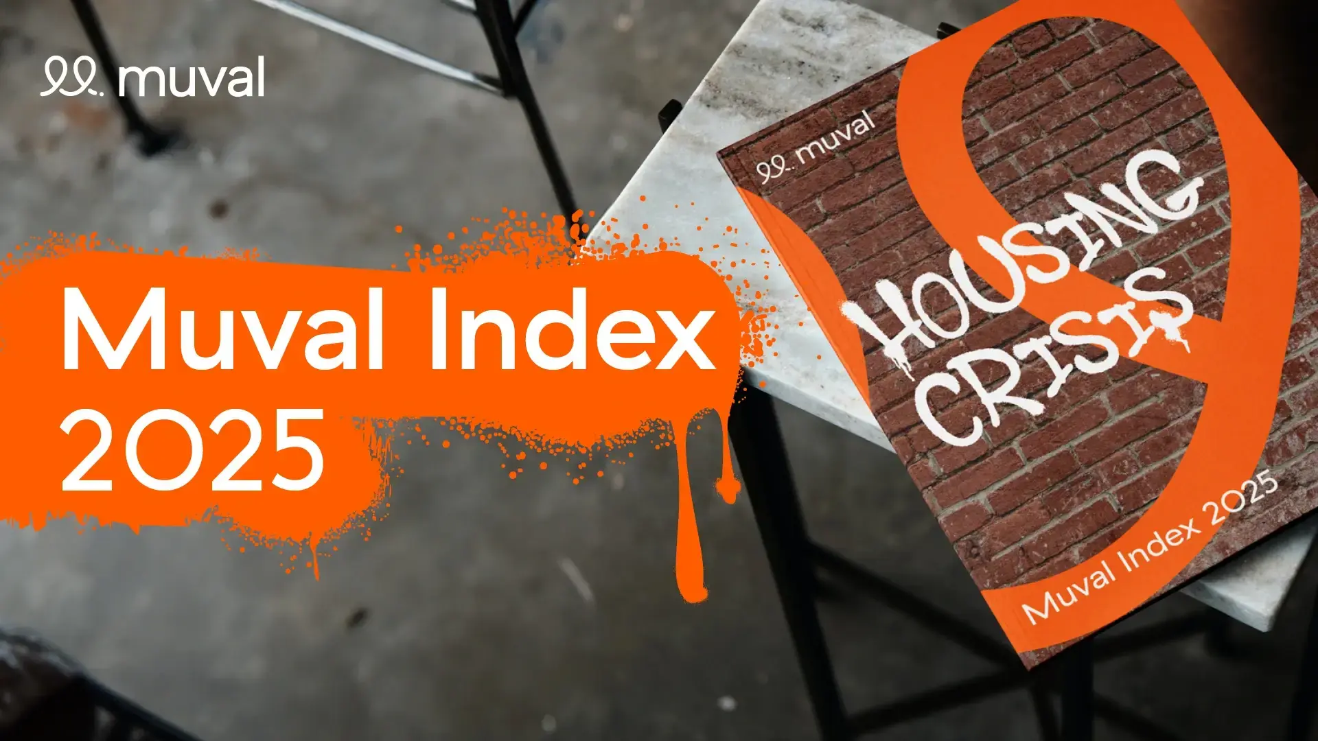 Birds-eye view of Muval Index publication sitting on side table in front of blurry concrete floor