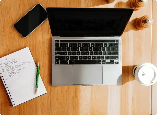 Top down look at a desk with a computer and notepad for planning a move