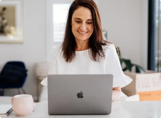 Front-on view of woman on laptop booking a relocation