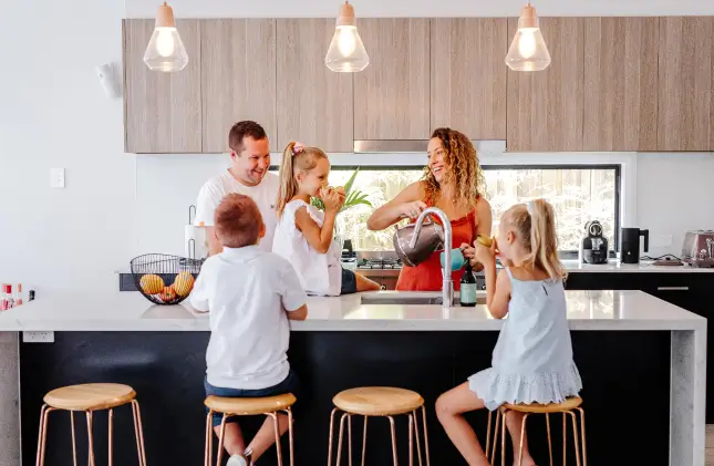 Mum, Dad and three kids in kitchen after moving house