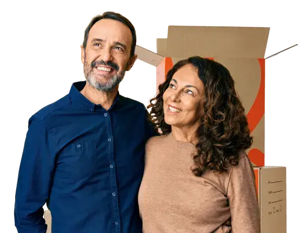 Couple hugging with moving boxes behind them
