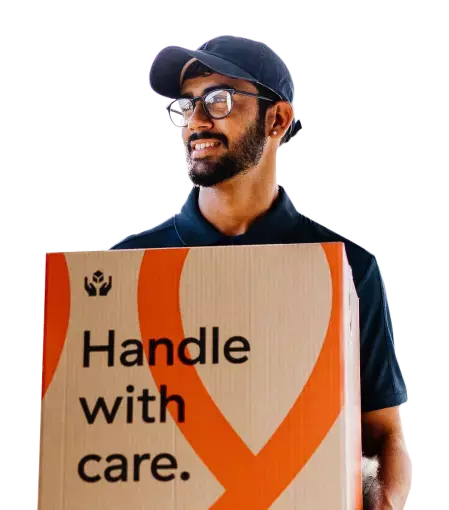 Removalist carrying a Muval moving box facing left